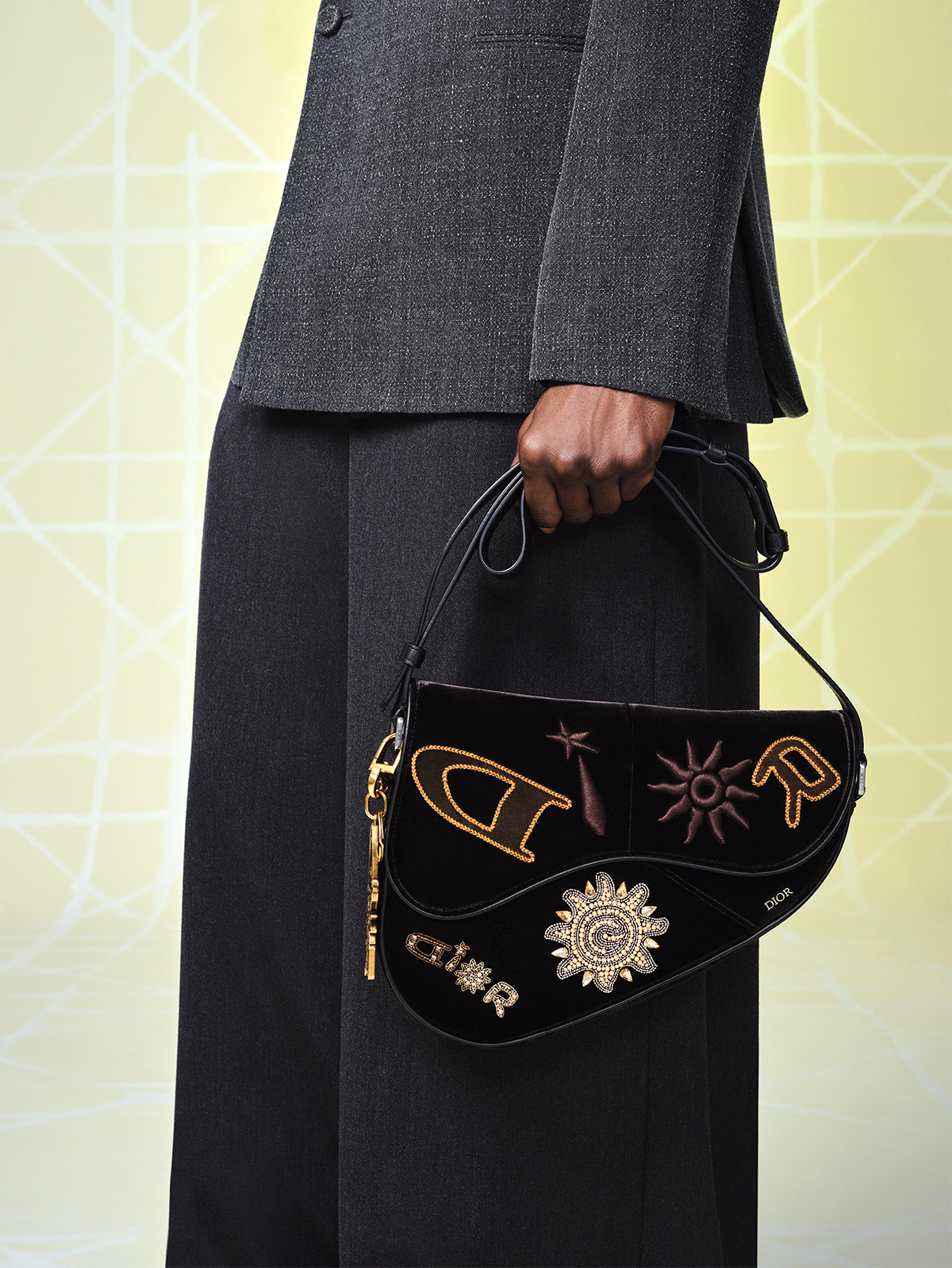 A detail photo taken by Kenny Germe for Dior of a suit and bag from Lewis Hamilton's capsule collection with the French fashion house.