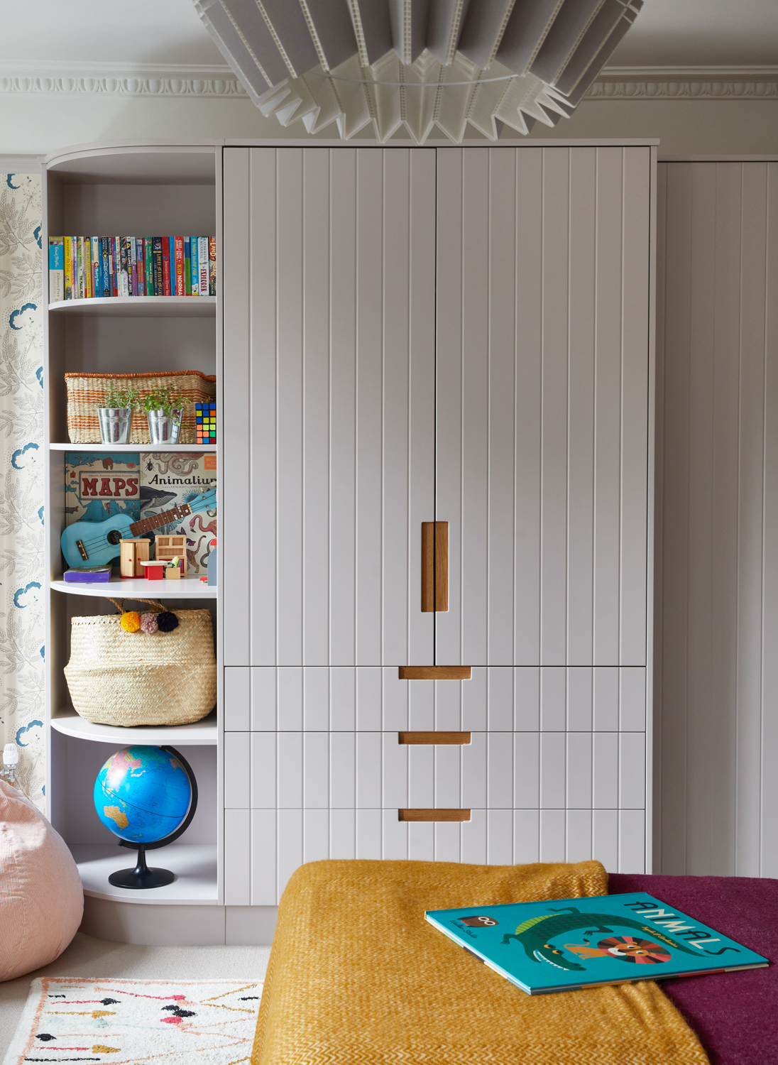 Image of a built-in wardrobe painted in a very pale pink with purple undertones in a kids bedroom.