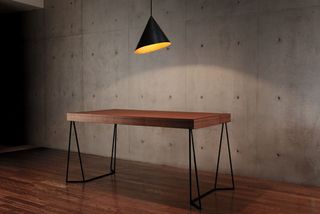 'Cartesia' table, by Nosigner for Colors. A dark wood topped table with black metal legs.