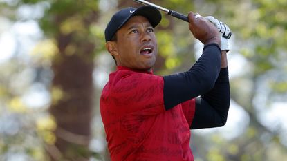 Tiger Woods plays a tee shot during the fourth round of the 2022 Masters