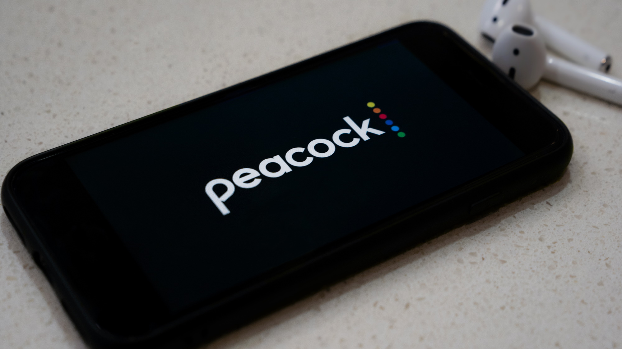 Peacock logo on an iPhone.