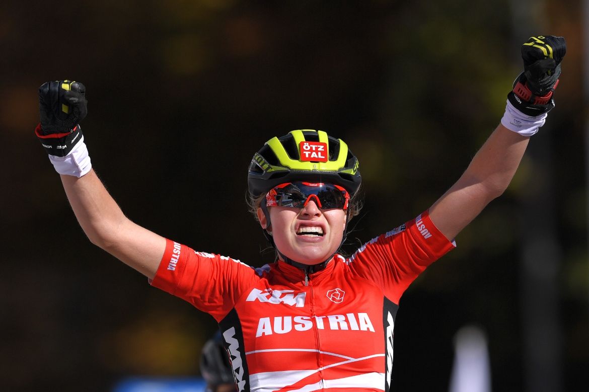 Laura Stigger raises her arms in celebration