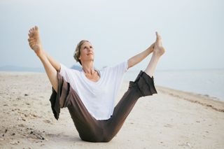 Yoga teacher Lorriane Taylor performs a wide angle balance
