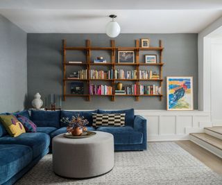 family room with teal sectional sofa and gray walls