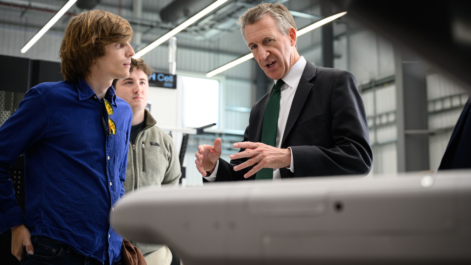 Britain's Defence Secretary Dan Jarvis (R) speaks the Chief Engineer Fraser McKay as he is shown the Skyhammer interceptor missile during a visit to Cambridge Aerospace