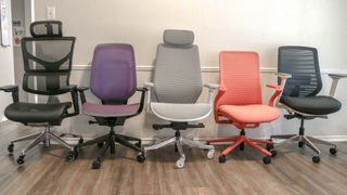Five different office chairs lined up in a row