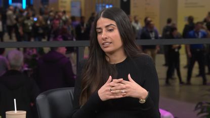 Asha Sharma in black shirt
