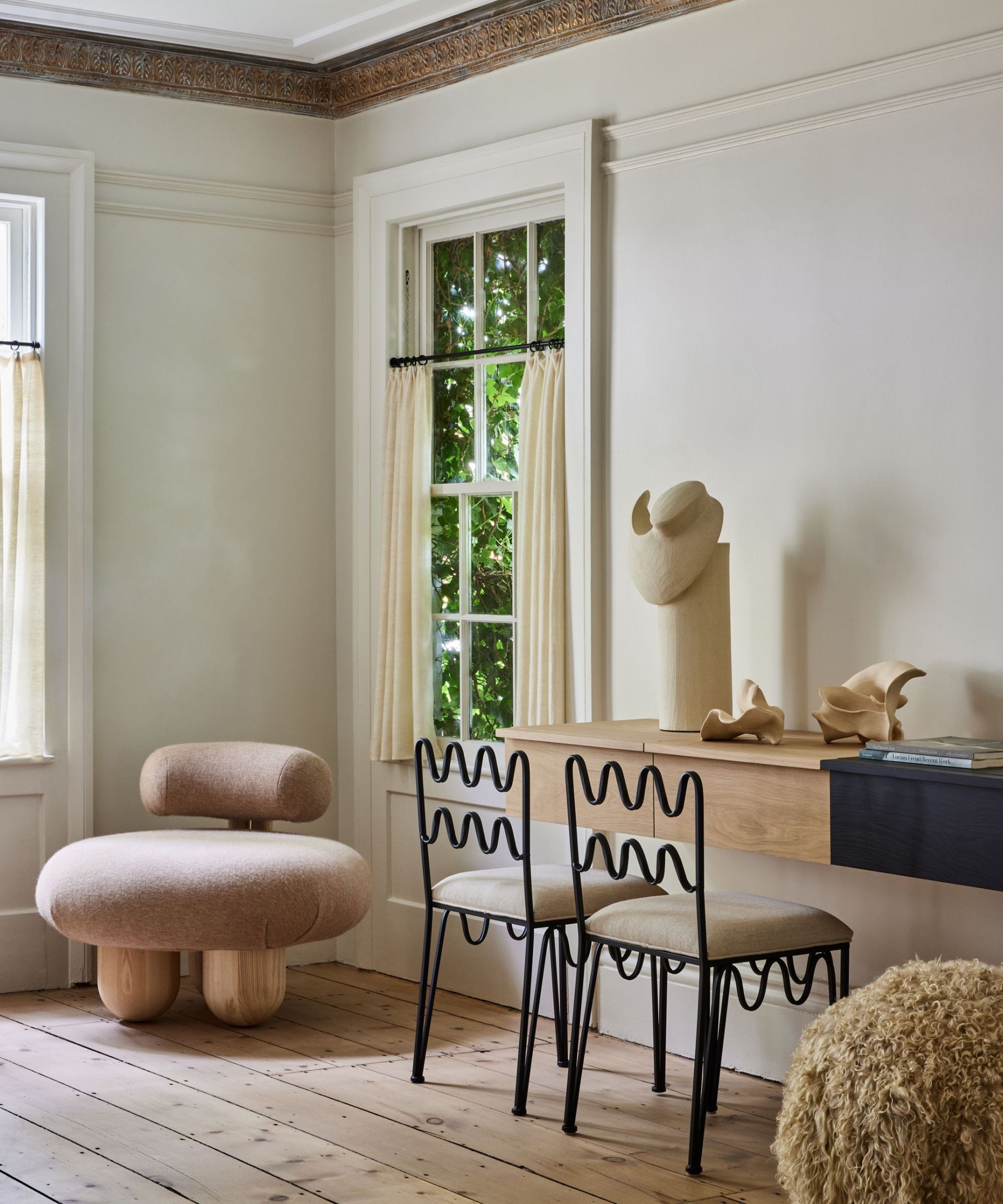Black chairs, fluffy stool, wooden table
