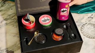 A selection of Pringles crisps and caviar in a black box