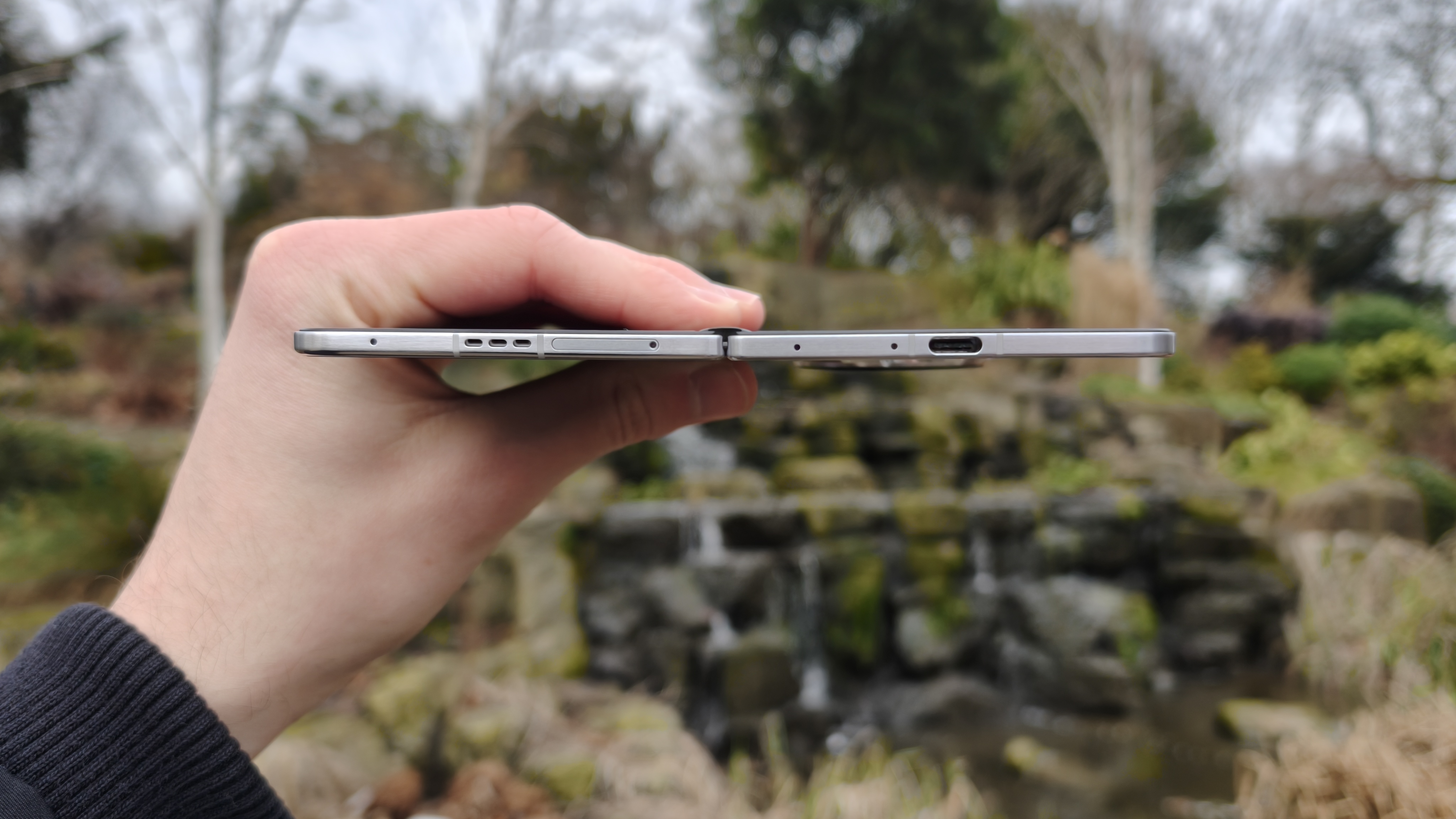 The bottom edge of the Oppo Find N5, waterfall in background