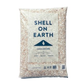A large transparent bag filled with crushed whelk shells, and with the name of the brand in blue on the front