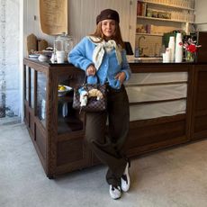 Girl wearing animal print shoes in cafe holding bag