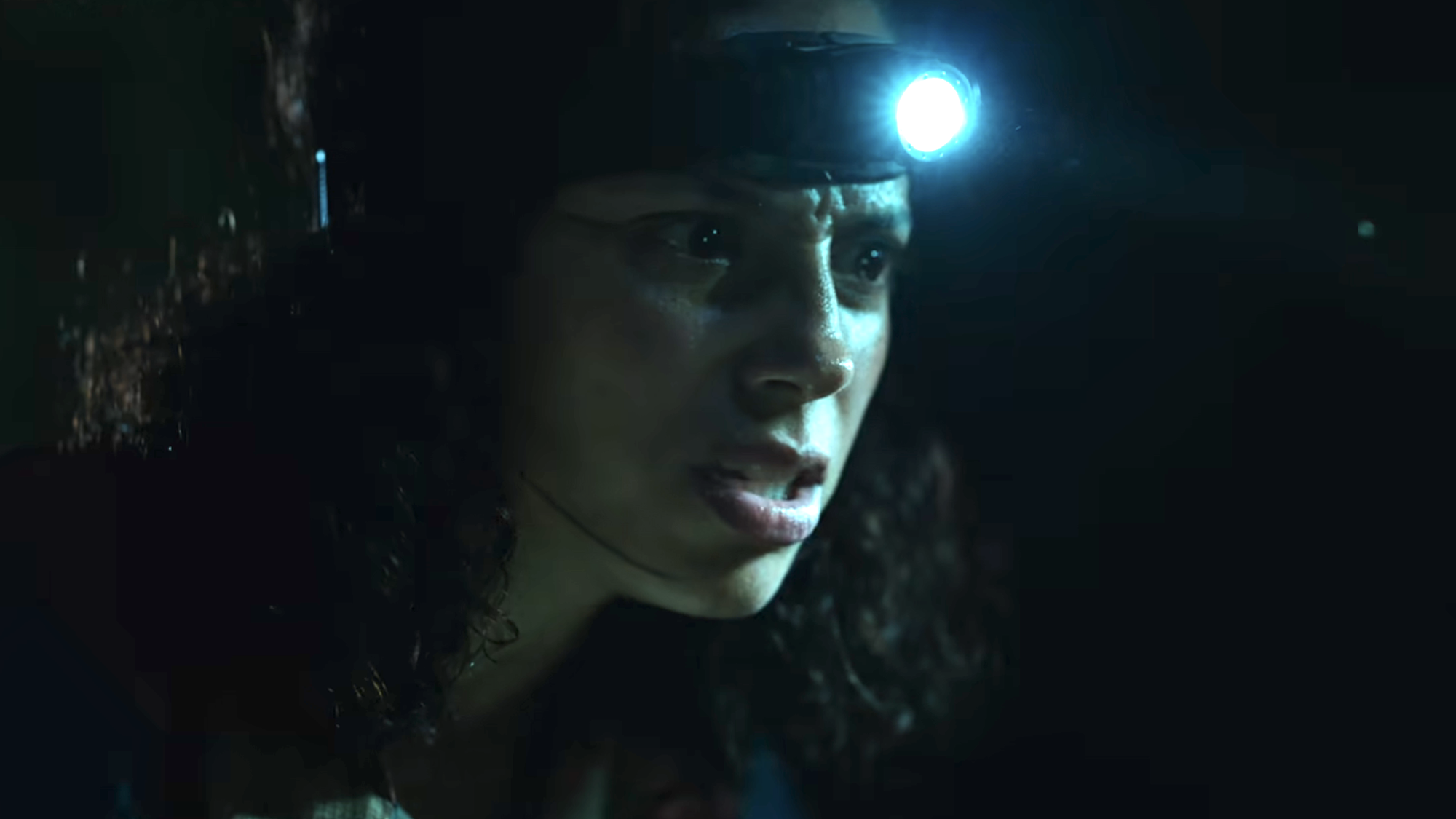 Kiana Madeira with a head flashlight on in Beware Boi&uacute;na
