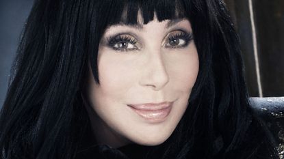 cher on a dark background