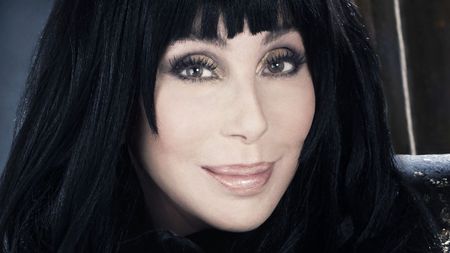 cher on a dark background