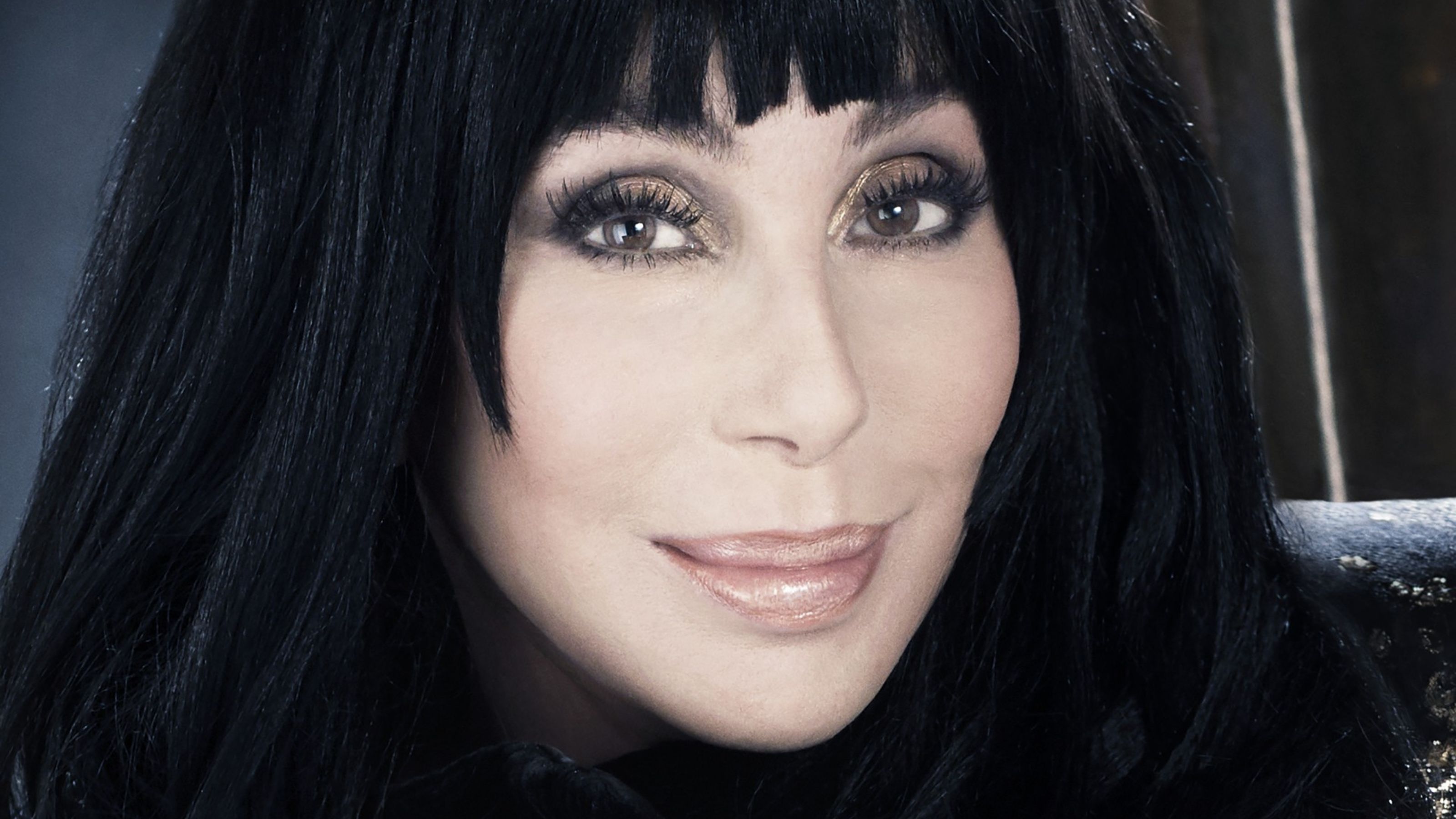 cher on a dark background