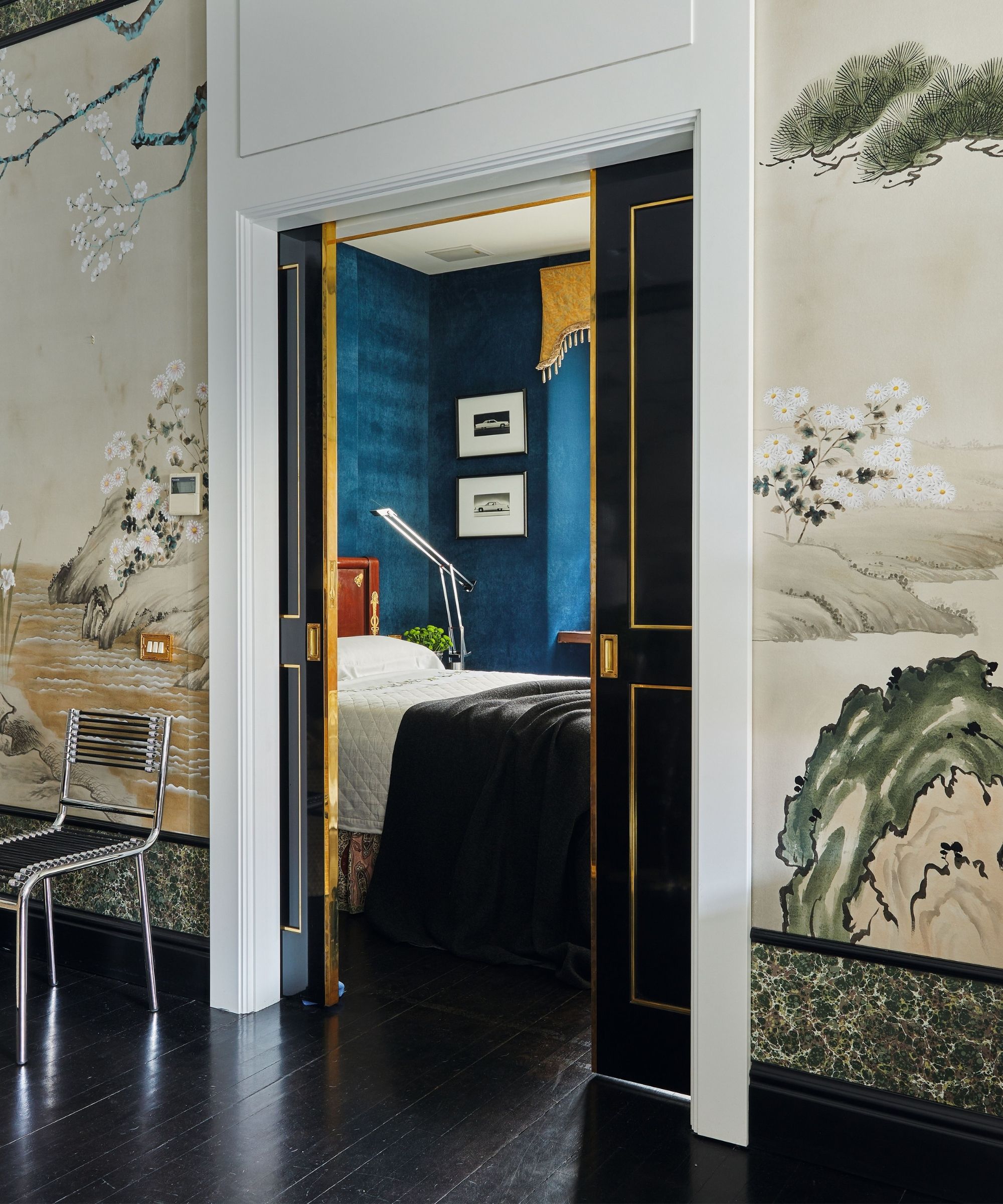 a mural wrapped room looking through a doorway into a blue bedroom