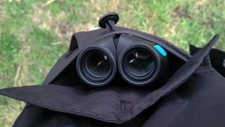 Photo of the Occer 12x25 compact binoculars inside a coat pocket