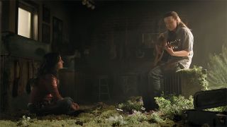 Dina sitting on the floor as Ellie plays the guitar on an upturned fridge in The Last of Us season 2 episode 4