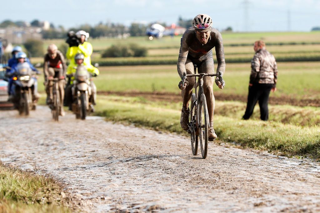 ROUBAIX FRANCE OCTOBER 03 Gianni Moscon of Italy and Team INEOS Grenadiers covered in mud attacks in the breakaway through cobblestones sector during the 118th ParisRoubaix 2021 Mens Eilte a 2577km race from Compigne to Roubaix ParisRoubaix on October 03 2021 in Roubaix France Photo by Bas CzerwinskiGetty Images