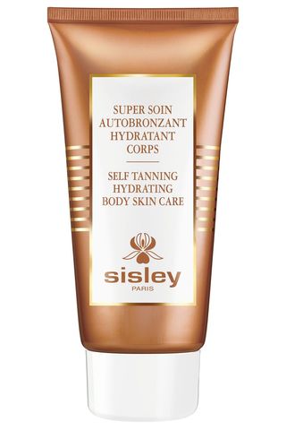 A bottle of Sisley Paris self-tanning hydrating body skin care set against a white background.