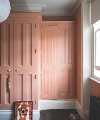 Pink peach painted built in wardrobe