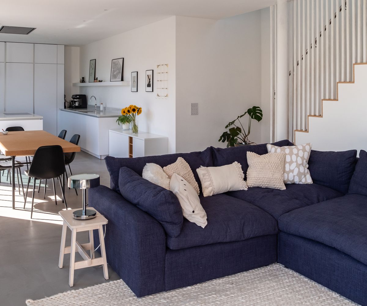 An open plan kitchen and dining room space with large corner sofa