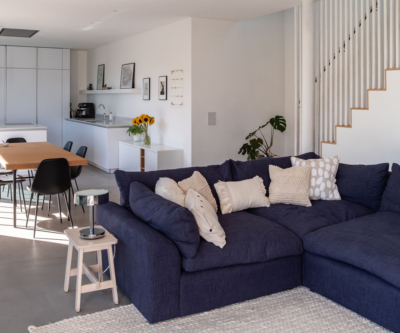 An open plan kitchen and dining room space with large corner sofa