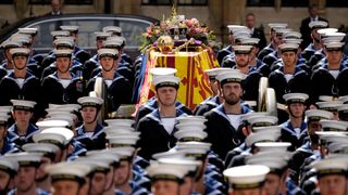 The coffin of Queen Elizabeth II with the Imperial State Crown resting on top, borne on the State Gun Carriage of the Royal Navy departs Westminster Abbey