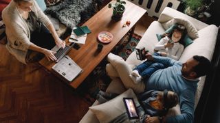 High angle shot of family using various connected devices at home