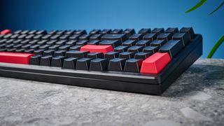 A black Lemokey X5 wired mechanical keyboard with red and black keycaps