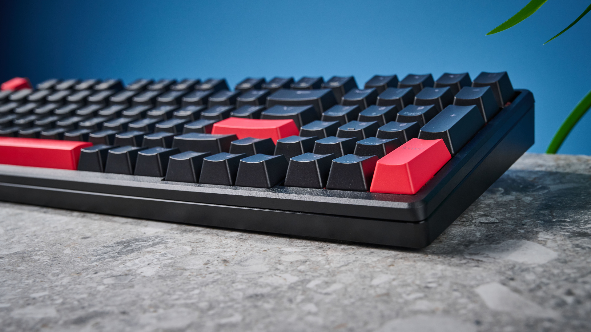 A black Lemokey X5 wired mechanical keyboard with red and black keycaps