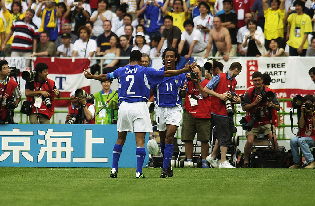 SHIZUOKA - JUNE 21: Ronaldinho (No.11) celebrates after scoring Brazil's second goal in the second half of the England v Brazil World Cup Quarter Final match played at the Shizuoka Stadium Ecopa in Shizuoka, Japan on June 21, 2002. Brazil won the match 2-1. (Photo by Ross Kinnaird/Getty Images)