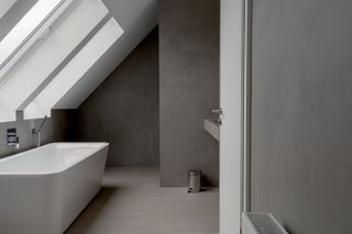 A grey microcemented bathroom