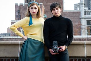 Aneurin Barnard stands on a London rooftop, holding a camera, accompanied by Karen Gillan