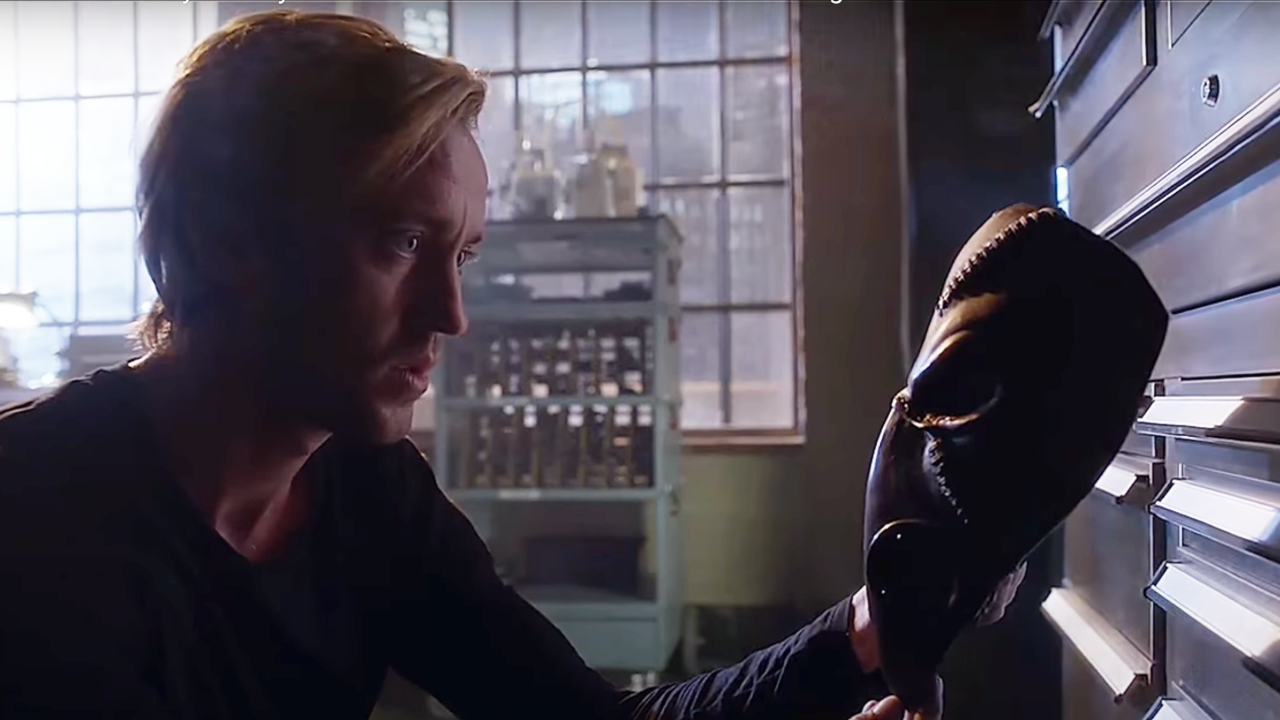 Tom Felton holding a mask on The Flash