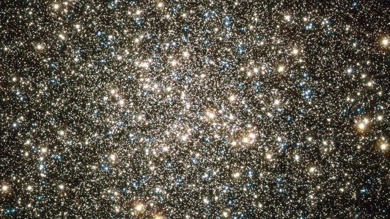 Stars glow brightly in tight clusters against the darkness of space