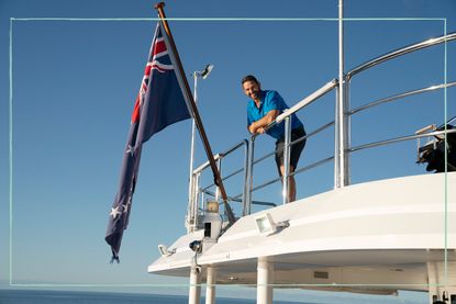 Captain Jason Chambers leaning over the railing of the yacht on Below Deck Down Under
