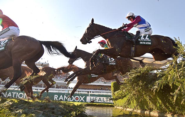 Grand National winner One For Arthur sails over the water jump