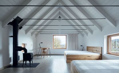 The pared-black guest room upstairs in Javornická Palírna. 