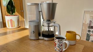Zwilling Enfinigy Drip Coffee Maker next to two mugs