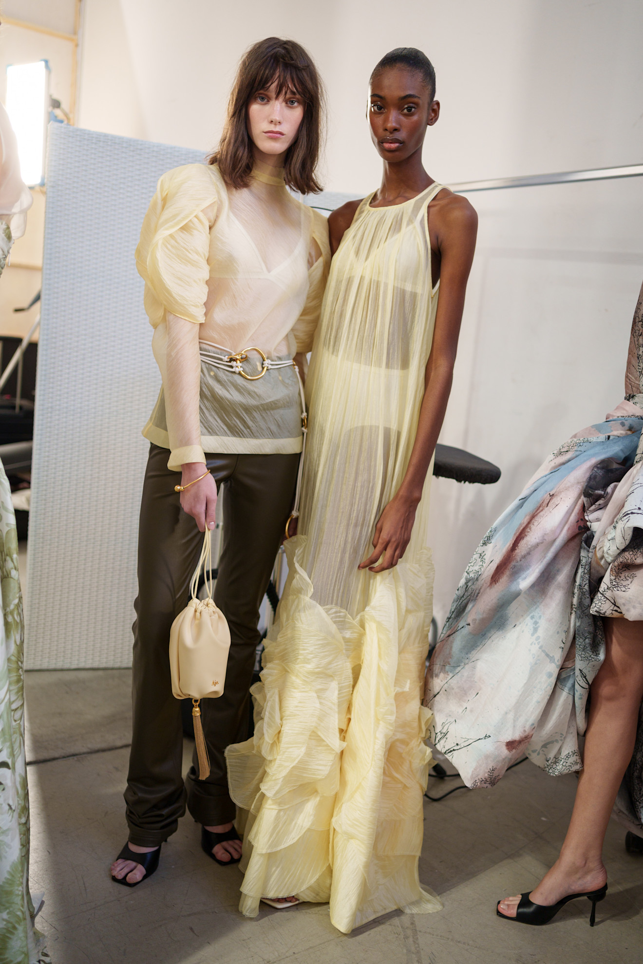 Models wearing yellow backstage at Aje SS26