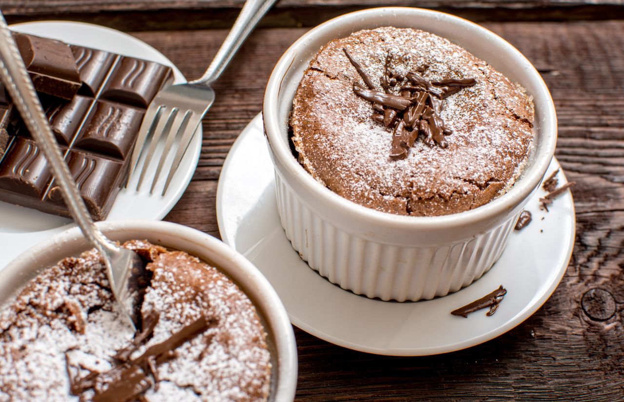 close up of two mini chocolate puddings dusted with icing sugar