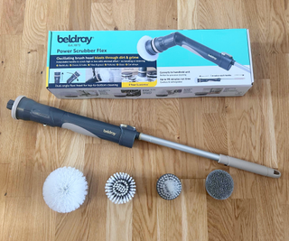 Beldray shower cleaner box and attachments on wooden floor