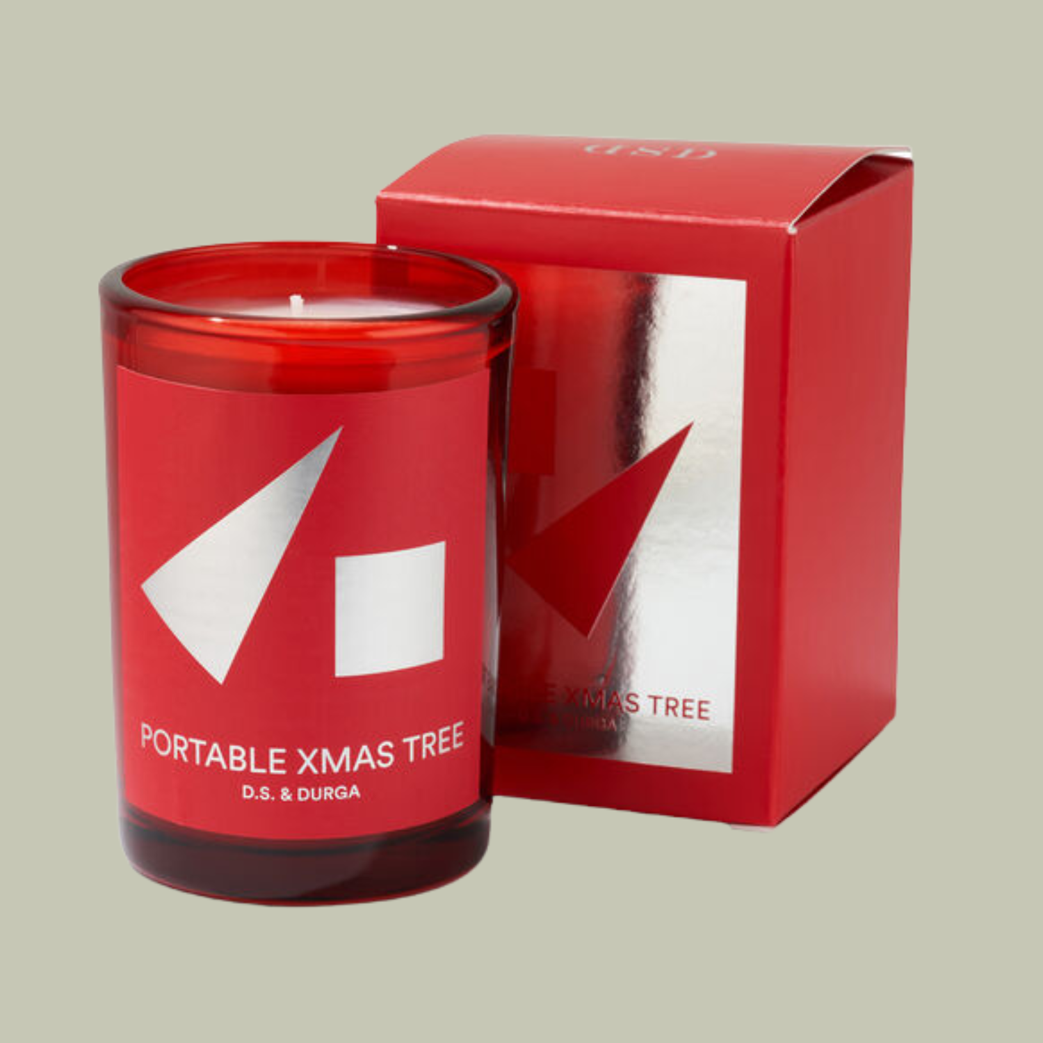 A portable xmas tree candle in a red vessel