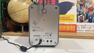 Ruark Audio R1S DAB radio on white shelf showing rear connections