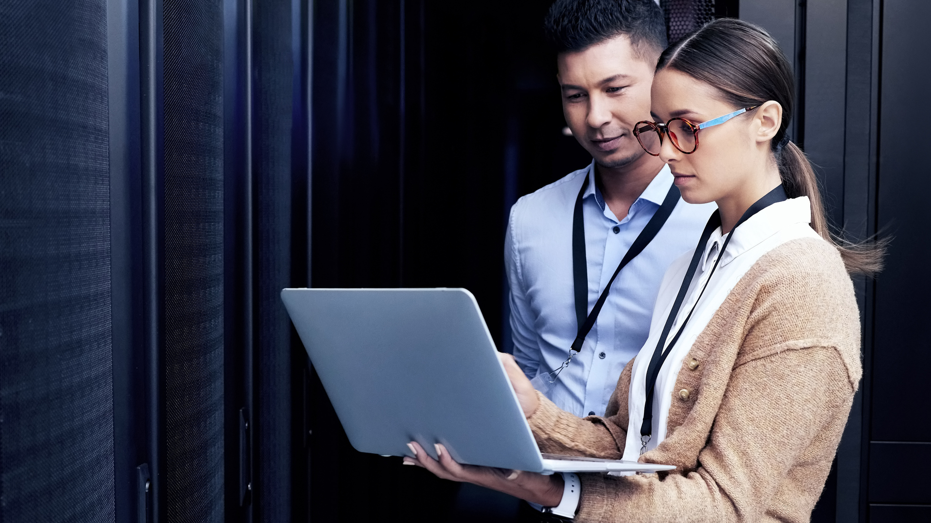Two people working in a data center