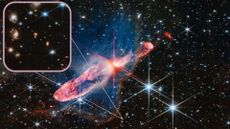 A galaxy shaped like a question mark against a dense field of stars and galaxies.