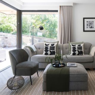 neutral and green living room with cosy sofas and throws