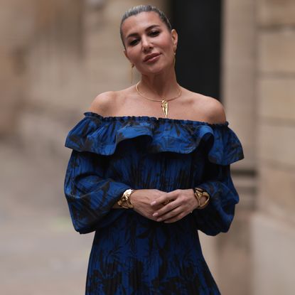 Best floral dresses: Olga Ferrara seen wearing Ungaro blue flower pattern off-shoulder pleated long dress, Amato gold jewerly, during Paris Fashion Week